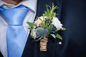 Natural flowers boutonniere in the pocket of the groom