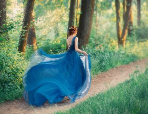 mysterious girl with red braided hair runs off from royal holiday, lady in long elegant blue dress with flying light train like flower, the magical transformation of beautiful woman during sunset