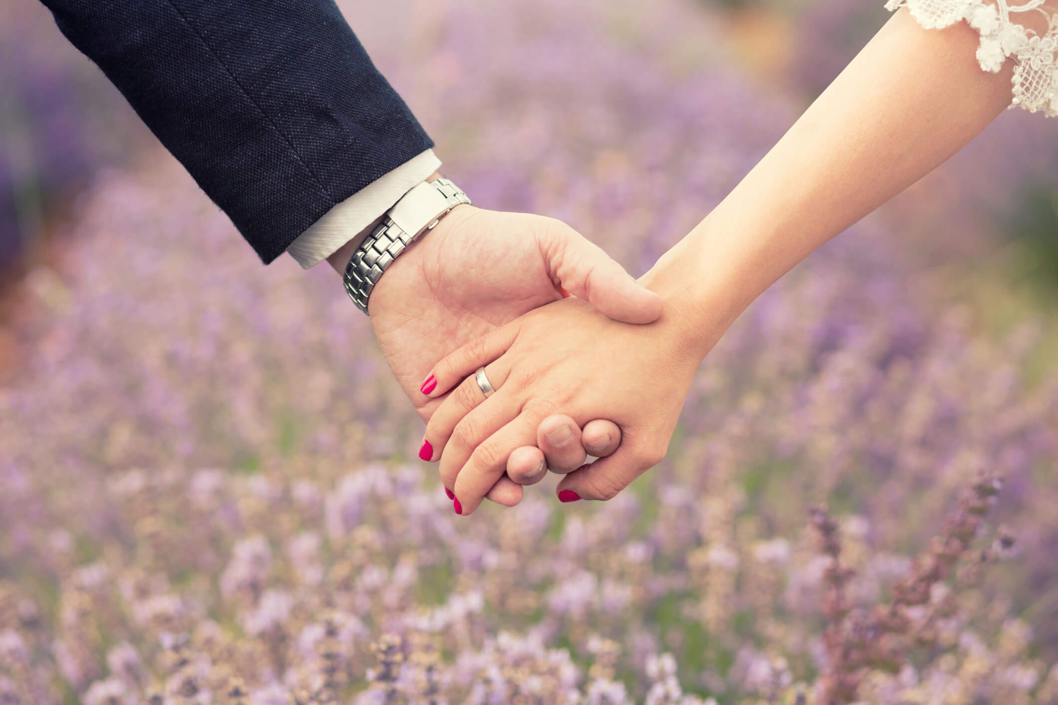 holding hands in front of lavender field